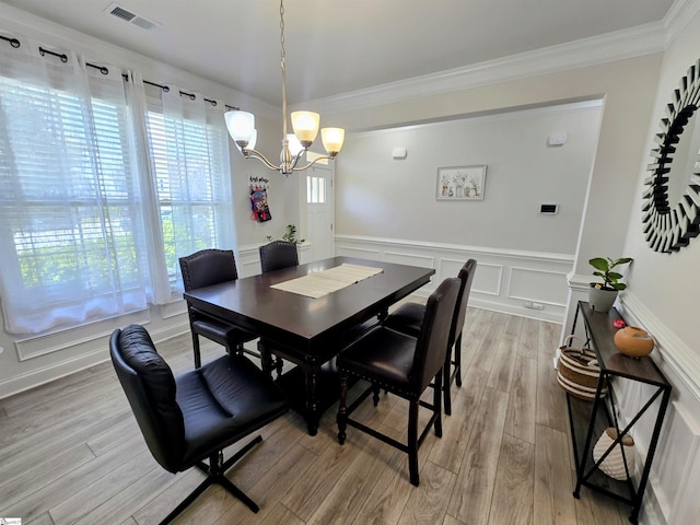 406 Willow Grove Way, Anderson, SC 29631 - dining space featuring a chandelier, crown molding, a wainscoted wall, light wood-style floors, and a decorative wall