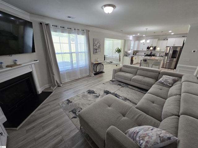 406 Willow Grove Way, Anderson, SC 29631 - living room featuring ornamental molding, light wood-type flooring, a fireplace, and recessed lighting