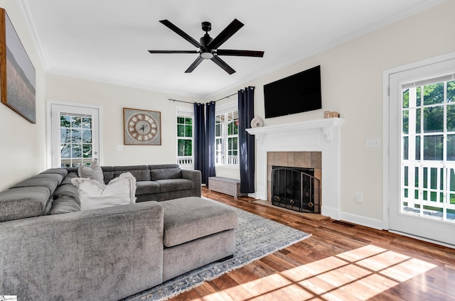 304 Camperdown Ct, Easley, SC 29642 - living area with crown molding, plenty of natural light, wood finished floors, a tiled fireplace, and a ceiling fan