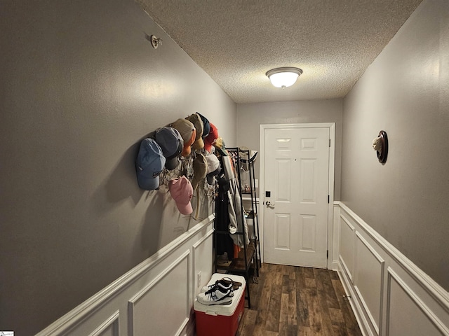 632 Lookover Dr, Anderson, SC 29621 - doorway featuring a textured ceiling, dark wood-style flooring, a decorative wall, and a wainscoted wall
