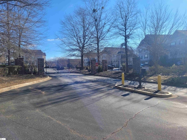 632 Lookover Dr, Anderson, SC 29621 - view of asphalt road with curbs, a gate, and a gated entry