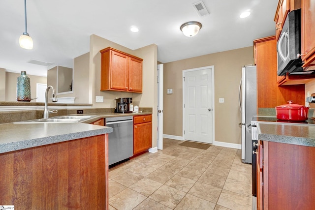 305 Cunningham Rd, Woodruff, SC 29388 - kitchen featuring stainless steel appliances, brown cabinets, a peninsula, pendant lighting, and light tile patterned floors
