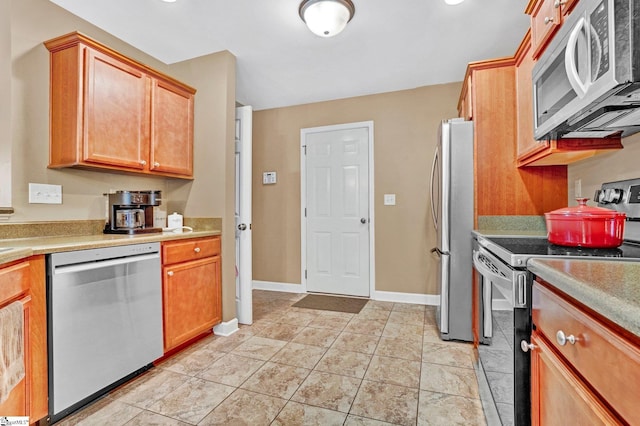 305 Cunningham Rd, Woodruff, SC 29388 - kitchen with appliances with stainless steel finishes, light countertops, and light tile patterned flooring
