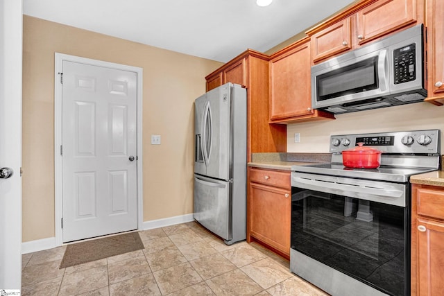305 Cunningham Rd, Woodruff, SC 29388 - kitchen with stainless steel appliances, light countertops, and brown cabinets