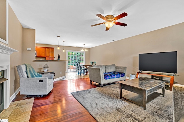 305 Cunningham Rd, Woodruff, SC 29388 - living room with a ceiling fan, a fireplace with flush hearth, a chandelier, and wood finished floors
