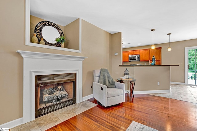 305 Cunningham Rd, Woodruff, SC 29388 - living area with light wood-type flooring and a fireplace with flush hearth
