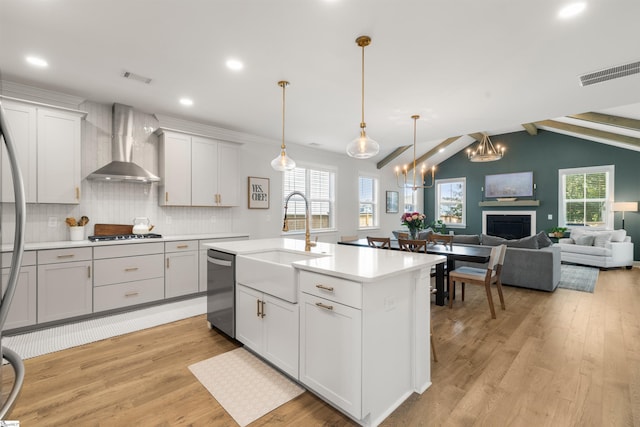 349 Encampment Blvd, Simpsonville, SC 29681 - kitchen featuring wall chimney exhaust hood, dishwasher, light wood finished floors, light countertops, and tasteful backsplash