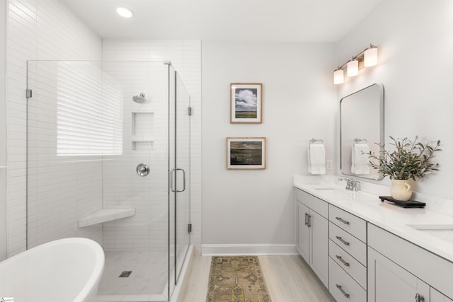 349 Encampment Blvd, Simpsonville, SC 29681 - bathroom with double vanity, a freestanding tub, a stall shower, and recessed lighting