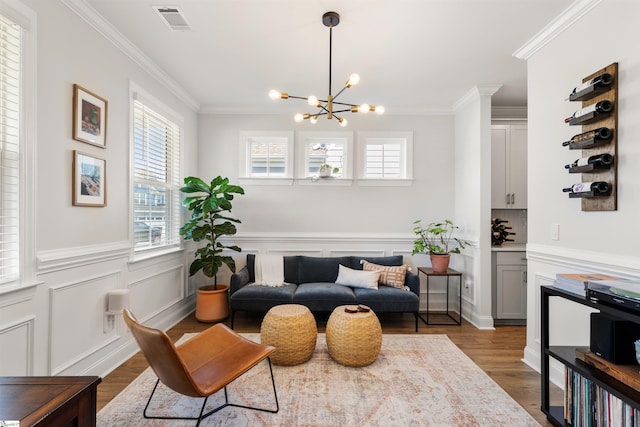 349 Encampment Blvd, Simpsonville, SC 29681 - sitting room featuring crown molding, plenty of natural light, dark wood finished floors, a chandelier, and wainscoting