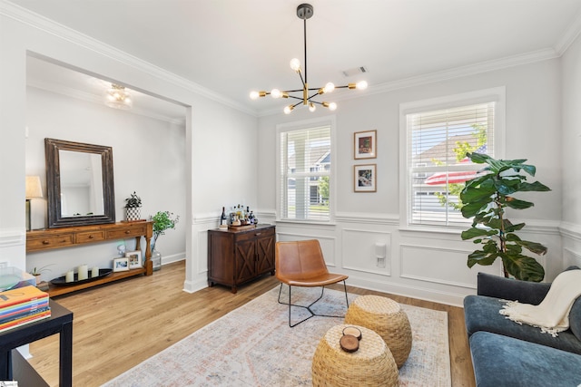 349 Encampment Blvd, Simpsonville, SC 29681 - living area featuring wood finished floors, a chandelier, crown molding, and a wainscoted wall