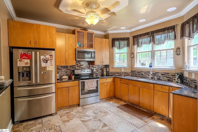 126 Midland Dr, Easley, SC 29640 - kitchen featuring stainless steel appliances, a ceiling fan, crown molding, brown cabinetry, and backsplash