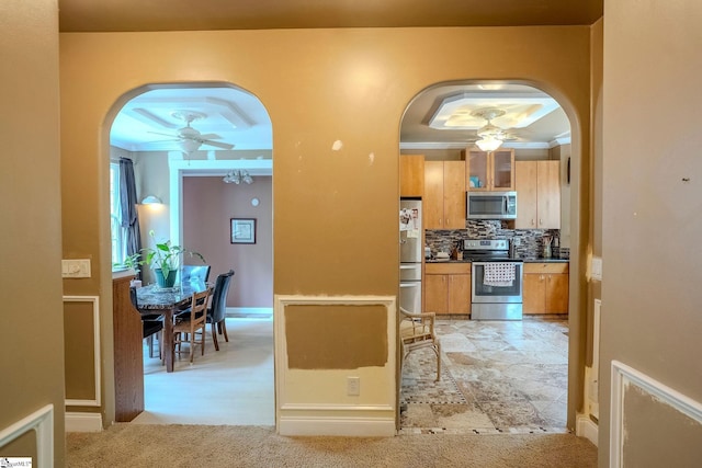 126 Midland Dr, Easley, SC 29640 - kitchen with stainless steel appliances, a ceiling fan, crown molding, arched walkways, and decorative backsplash
