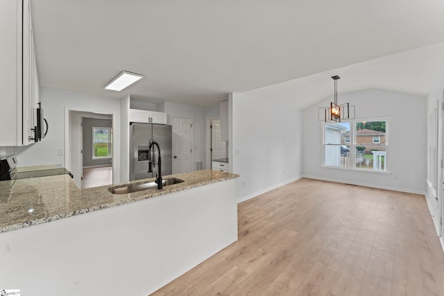 2005 Gap Creek Rd, Greer, SC 29651 - kitchen featuring appliances with stainless steel finishes, light stone countertops, a peninsula, lofted ceiling, and white cabinetry