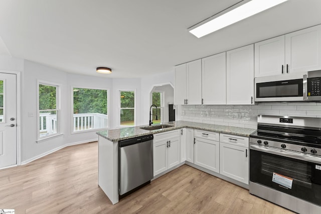 2005 Gap Creek Rd, Greer, SC 29651 - kitchen featuring stainless steel appliances, white cabinetry, light wood-style floors, and backsplash