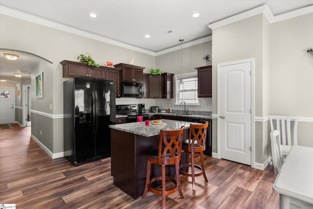 906 John Thomas Way, Greer, SC 29651 - kitchen featuring black appliances, a center island, dark brown cabinets, dark wood finished floors, and arched walkways