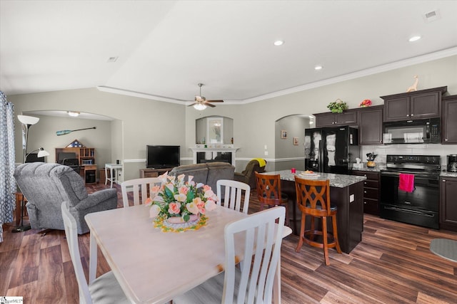 906 John Thomas Way, Greer, SC 29651 - dining space featuring arched walkways, ceiling fan, dark wood-style floors, a fireplace, and lofted ceiling