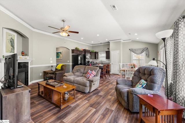 906 John Thomas Way, Greer, SC 29651 - living area featuring dark wood-style flooring, a ceiling fan, a tiled fireplace, lofted ceiling, and arched walkways
