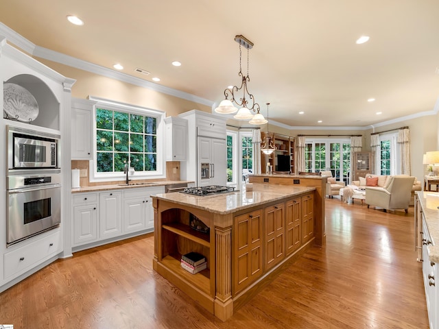 24 Lake Hills Ln, Travelers Rest, SC 29690 - kitchen with built in appliances, open shelves, open floor plan, white cabinetry, and ornamental molding