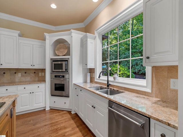 24 Lake Hills Ln, Travelers Rest, SC 29690 - kitchen featuring stainless steel appliances, tasteful backsplash, plenty of natural light, and ornamental molding