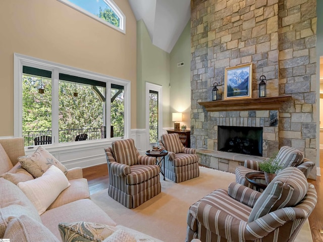 24 Lake Hills Ln, Travelers Rest, SC 29690 - living room featuring a fireplace, high vaulted ceiling, wainscoting, and wood finished floors