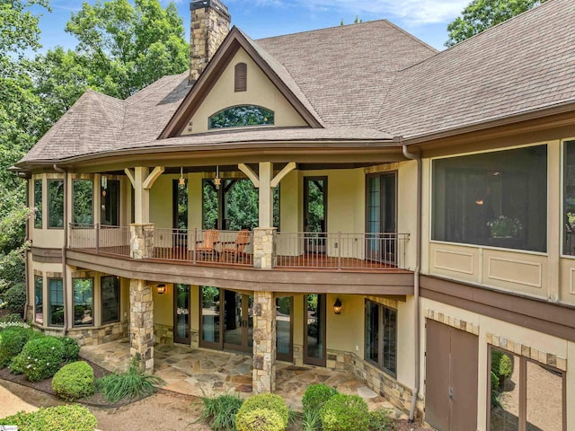 24 Lake Hills Ln, Travelers Rest, SC 29690 - rear view of house featuring stucco siding, a chimney, a patio area, and a shingled roof