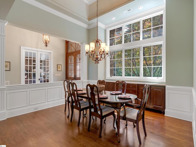 24 Lake Hills Ln, Travelers Rest, SC 29690 - dining room featuring a chandelier, ornamental molding, a wainscoted wall, a decorative wall, and wood finished floors