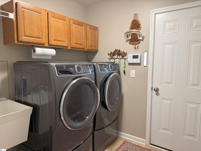 9 Kenton Finch Ct, Simpsonville, SC 29681 - laundry area with washing machine and clothes dryer, cabinet space, and light tile patterned floors