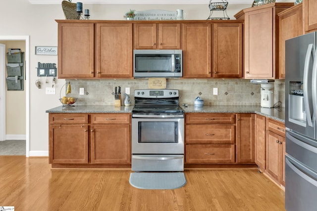 112 Friesian Ct, Pelzer, SC 29669 - kitchen featuring appliances with stainless steel finishes, light wood finished floors, backsplash, and light stone countertops