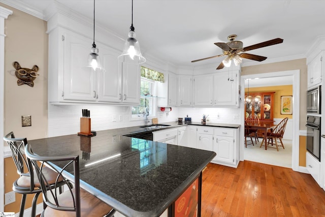 14 Quail Meadow Ln, Greenville, SC 29617 - kitchen with a peninsula, white cabinets, stainless steel microwave, black oven, and crown molding