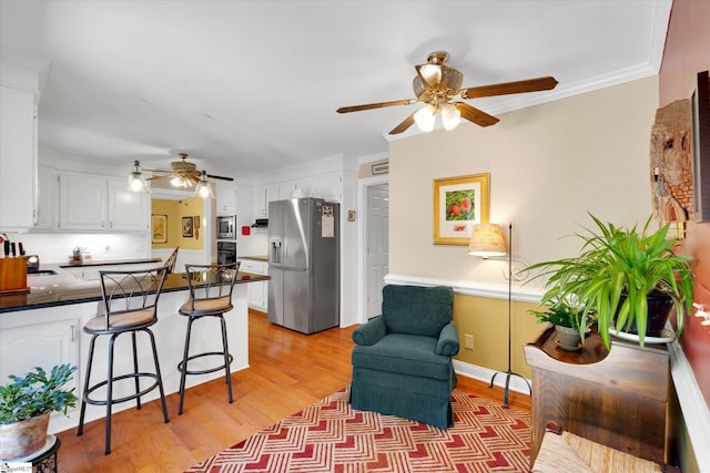 14 Quail Meadow Ln, Greenville, SC 29617 - kitchen featuring stainless steel appliances, a ceiling fan, a peninsula, dark countertops, and white cabinetry