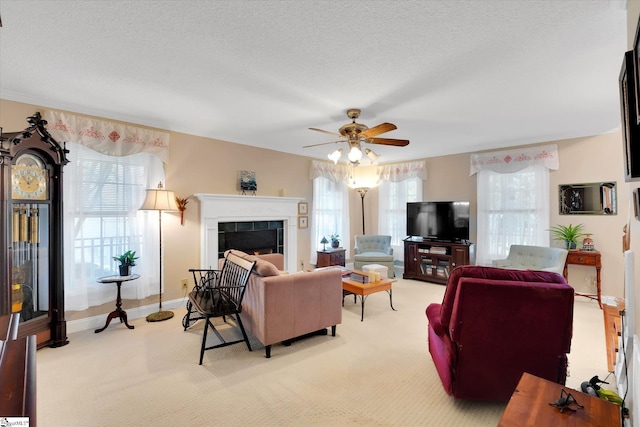 14 Quail Meadow Ln, Greenville, SC 29617 - living room featuring light colored carpet, a tiled fireplace, a ceiling fan, and a textured ceiling