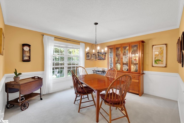 14 Quail Meadow Ln, Greenville, SC 29617 - dining space with a chandelier, a textured ceiling, wainscoting, light carpet, and crown molding