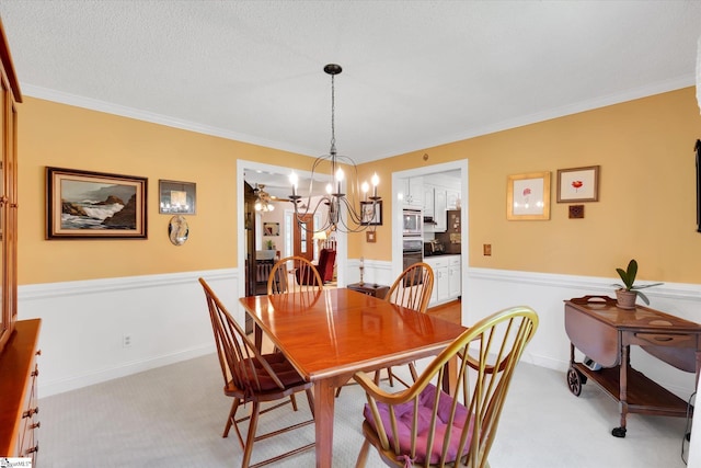 14 Quail Meadow Ln, Greenville, SC 29617 - dining space featuring a chandelier, crown molding, light carpet, and wainscoting