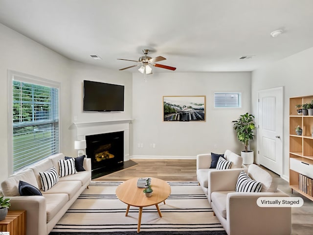 163 Highland Park Ct, Easley, SC 29642 - living area with a ceiling fan, wood finished floors, and a fireplace with flush hearth