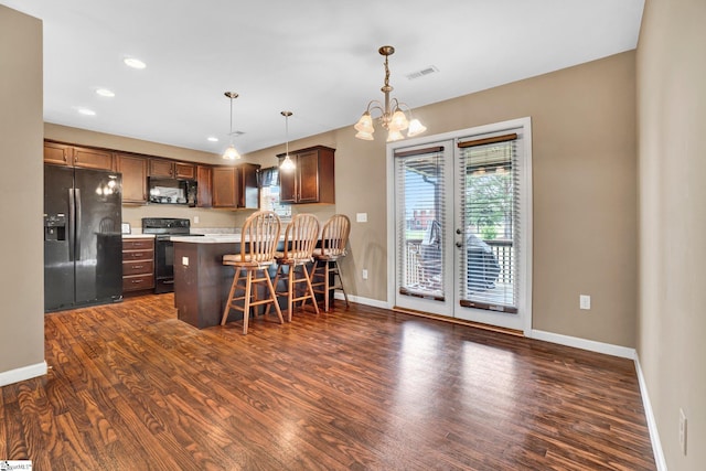 102 Tea Leaf Ct, Anderson, SC 29626 - kitchen featuring black appliances, dark wood-type flooring, a breakfast bar area, french doors, and recessed lighting