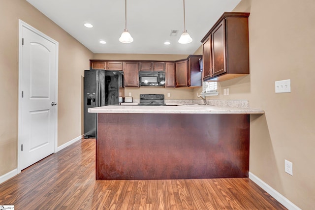 102 Tea Leaf Ct, Anderson, SC 29626 - kitchen featuring black appliances, a peninsula, wood finished floors, pendant lighting, and recessed lighting