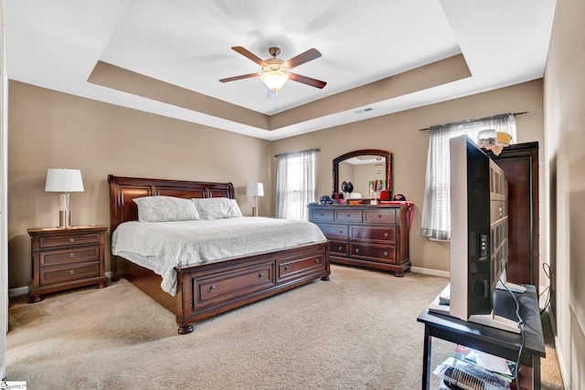102 Tea Leaf Ct, Anderson, SC 29626 - bedroom featuring a tray ceiling, light carpet, and a ceiling fan