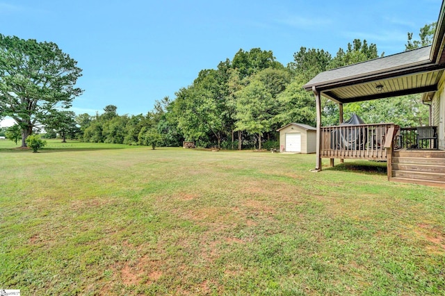 102 Tea Leaf Ct, Anderson, SC 29626 - view of grassy yard with a shed, a garage, a deck, and view of wooded area