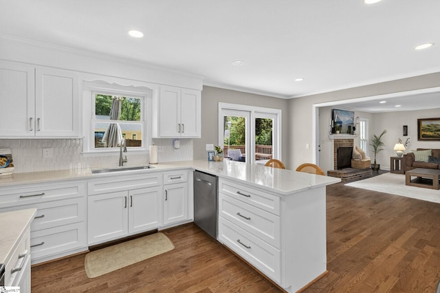103 W Shallowstone Rd, Greer, SC 29650 - kitchen featuring dishwasher, a peninsula, white cabinets, tasteful backsplash, and a fireplace
