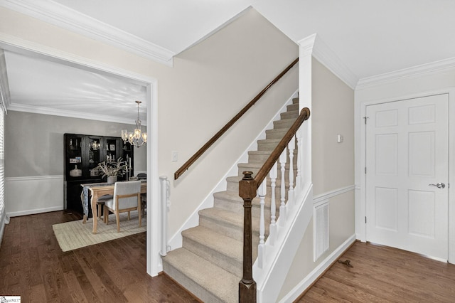 103 W Shallowstone Rd, Greer, SC 29650 - stairway featuring crown molding, wood finished floors, a chandelier, and wainscoting