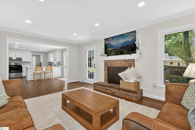 103 W Shallowstone Rd, Greer, SC 29650 - living room featuring wood finished floors, recessed lighting, ornamental molding, and a brick fireplace