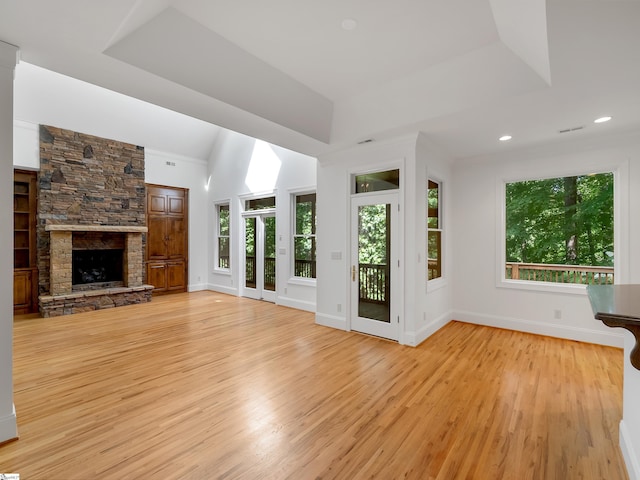 1 Touch Me Not Trl, Landrum, SC 29356 - unfurnished living room with light wood finished floors, a stone fireplace, lofted ceiling, and recessed lighting