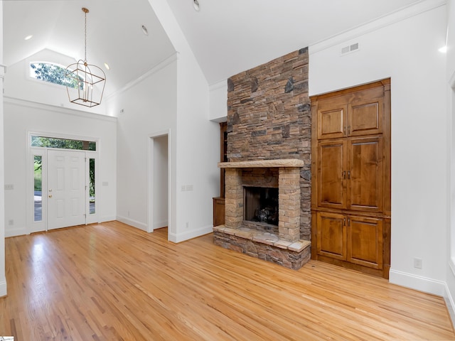 1 Touch Me Not Trl, Landrum, SC 29356 - unfurnished living room featuring high vaulted ceiling, light wood finished floors, a chandelier, and a fireplace
