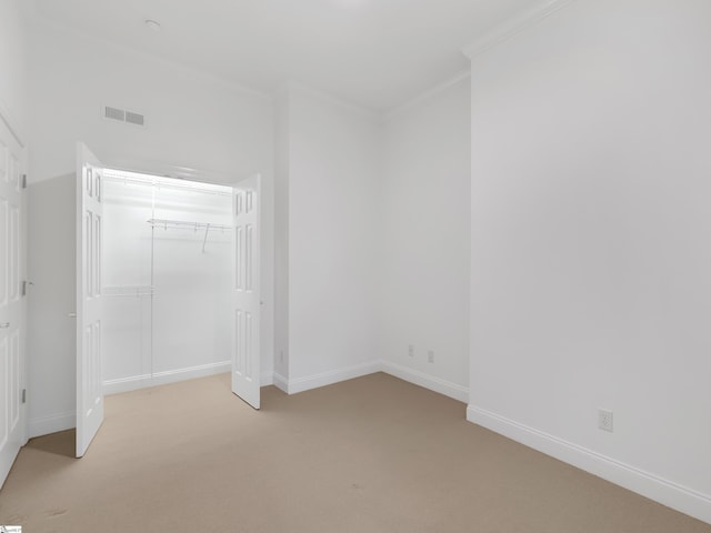 1 Touch Me Not Trl, Landrum, SC 29356 - unfurnished bedroom featuring light colored carpet, crown molding, and a closet