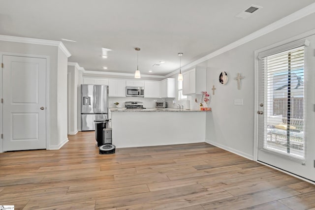 353 Anna Gray Cir, Easley, SC 29640 - kitchen with appliances with stainless steel finishes, crown molding, healthy amount of natural light, a peninsula, and white cabinets