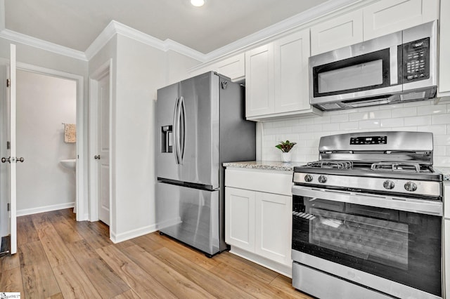 353 Anna Gray Cir, Easley, SC 29640 - kitchen with stainless steel appliances, crown molding, light wood finished floors, white cabinets, and decorative backsplash