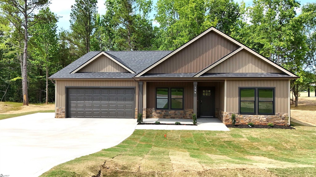 124 Susans Rd, Gaffney, SC 29341 - view of front facade with roof with shingles, a garage, concrete driveway, stone siding, and a front lawn