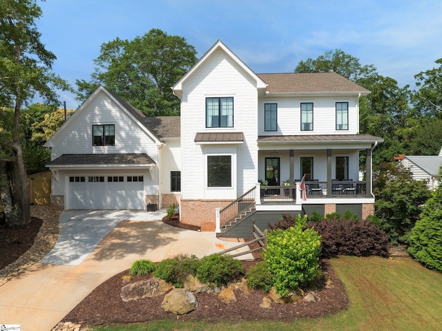 352 Pine Forest Drive Extension, Greenville, SC 29605 - view of front facade with covered porch, a standing seam roof, concrete driveway, an attached garage, and brick siding
