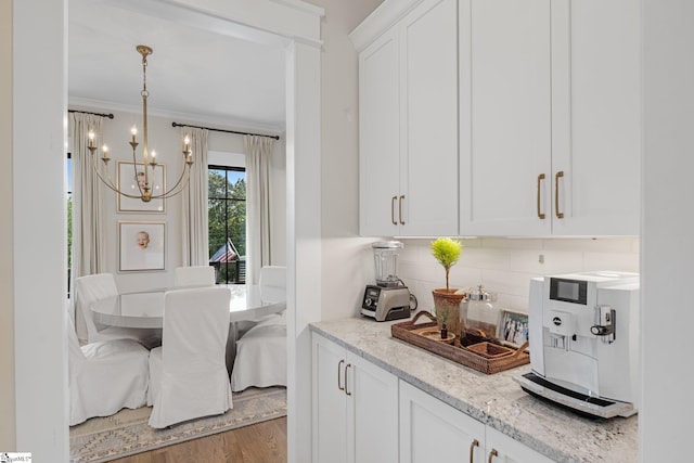 352 Pine Forest Drive Extension, Greenville, SC 29605 - kitchen featuring a chandelier, backsplash, white cabinetry, light wood-style flooring, and light stone countertops