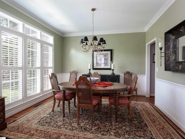 4 Glens Crossing Ct, Greer, SC 29650 - dining room with a chandelier, healthy amount of natural light, ornamental molding, wood finished floors, and a wainscoted wall
